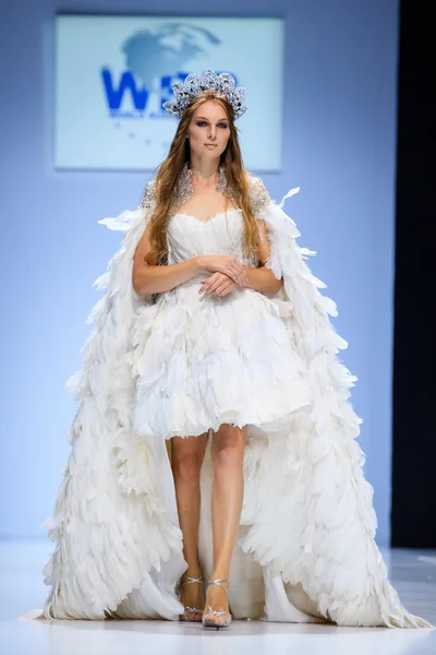 Model walk runway for WORLD RUSSIAN BEAUTY catwalk at Spring-summer 2017 Moscow Fashion Week. Clothes in national ethnic style.