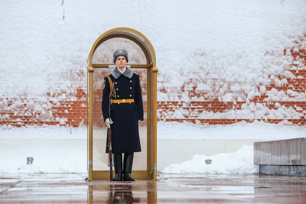 Guard of the Presidential regiment of Russia near Tomb of Unknown soldier and Eternal flame in Alexander garden near Kremlin wall. Winter view.