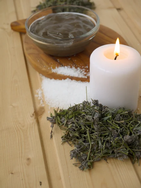 Mud,salt,candle and dry lavender on the wooden background