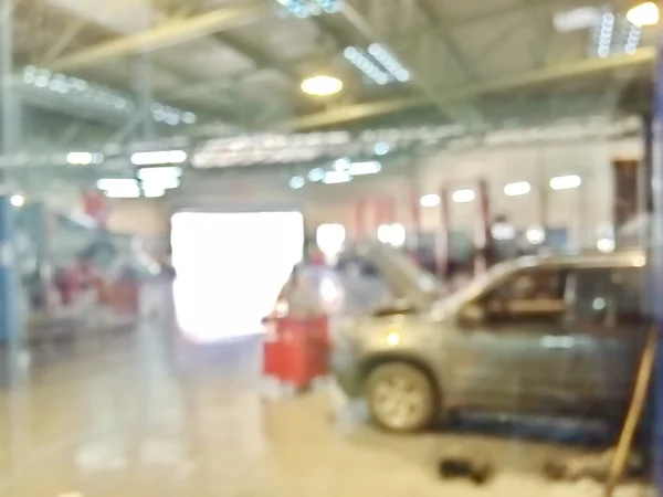 Blurred environment inside the garage with technician