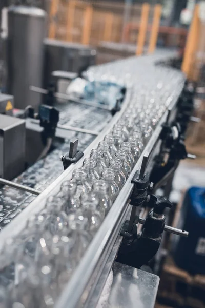 Robotic factory line bottling water into bottles