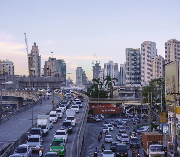 Traffic jam in the evening with high-rise building in background