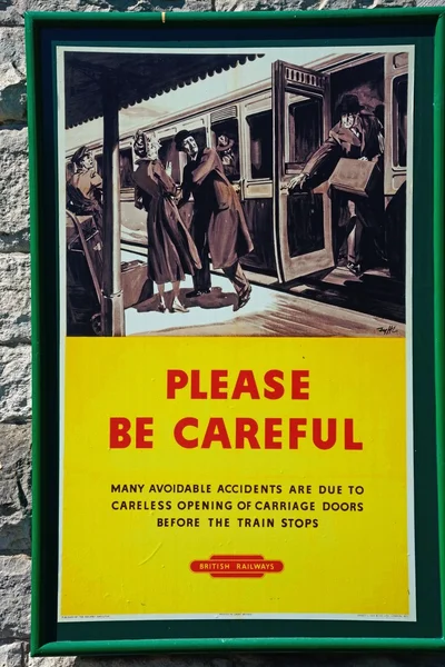 Old fashioned British Railways Be Careful poster at the railway station, Corfe.