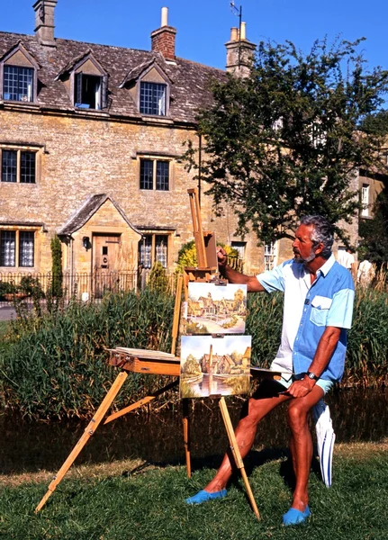 Artist with his easel painting along the River Eye, Lower Slaughter.