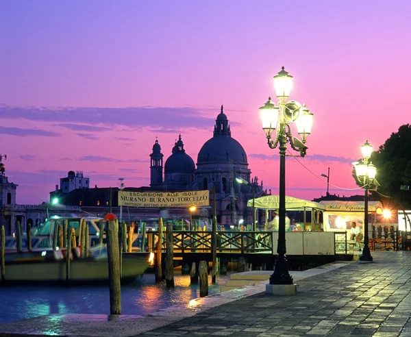 Quayside with the church of Santa Maria Della Salute to the rear at sunset, Venice.