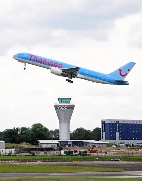 Thomson Airways Boeing 757 200 (G-OOBJ) series taking off over the new control tower at Birmingham Airport, Birmingham.