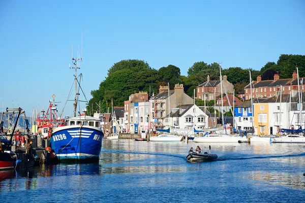 View of fishing boats and quayside buildings in the harbour, Weymouth.