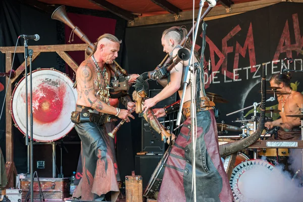 Heidelberg, Germany - September 25 2016. Musicians stylized as the Goths performing on folk festival and playing bagpipes rock