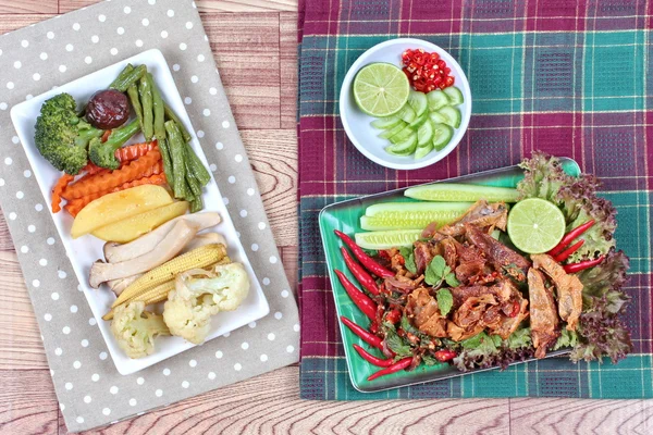 Spicy sour mixed herb salad with fried stir taro in tofu sheet served with fried  mixed vegetables for  in Vegetable festival of Chinese as \