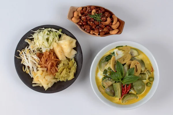 Green fermented flour curry  with mixed vegetables and spicy fried textured soy protein curry served with side disk as bean sprouts,cabbage,sweet radish and pickle