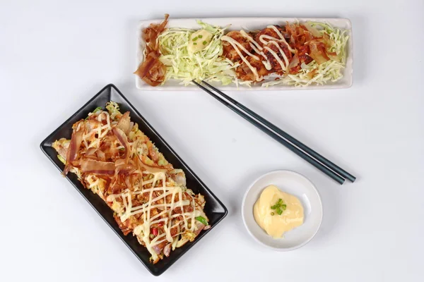 Grill flour wrap squid (as Takoyaki) served with Japan pizza (as Okonomiyaki) and side dish.