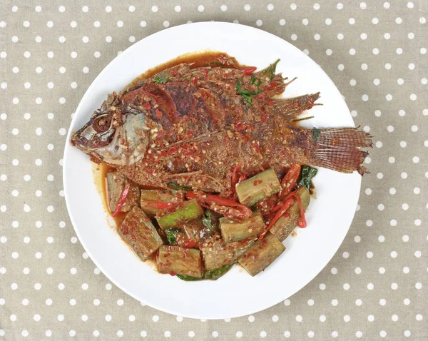 Deep-fried tilapia fish topped Spicy fried eggplant.