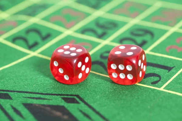 Roll of the red dice on  game table in  casino