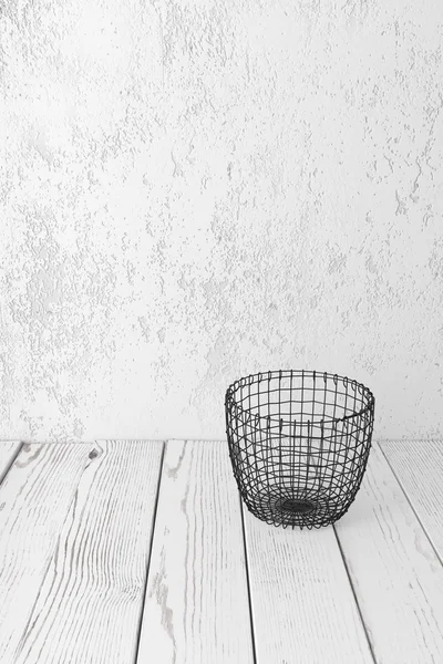Wire basket on white floor
