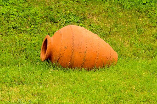 Kvevri (qvevri) ancient georgian Clay pottery for wine on fresh green grass. Kvevri is a large earthenware vessel used for the fermentation and storage of wine, often buried below ground level.