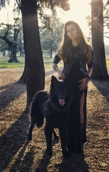 Beautiful girl with big black dog