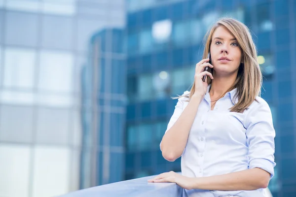 Beautiful Female Business Executive On Cell Phone In Modern City