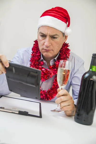 Business Man Celebrate Merry Christmas And Happy New Year Wear Santa Hat. Serious minded man thinking about way to solve his problems on new year eve
