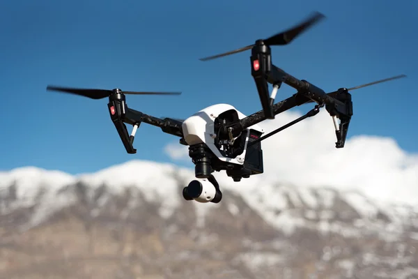 Quadcopter drone camera technology hovering in daylight