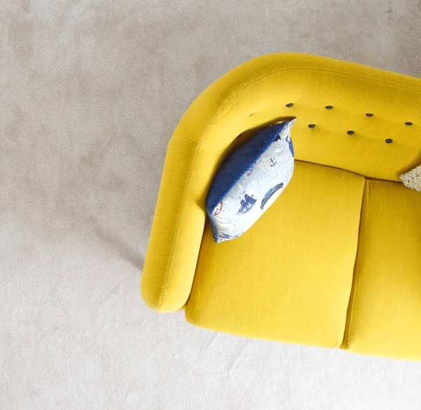 Blue throw pillow on yellow living room sofa furniture