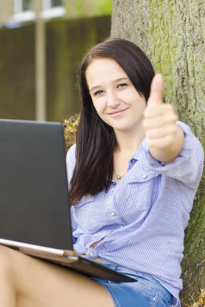 Woman with notebook in a park