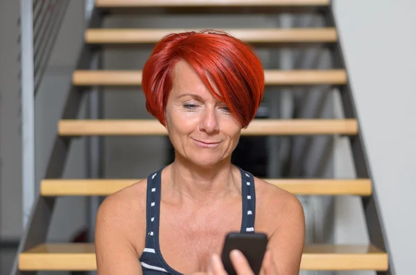 Pretty Adult Redhead Woman Texting on Mobile Phone