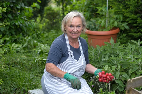 Senior Lady at the Garden Holding radishes