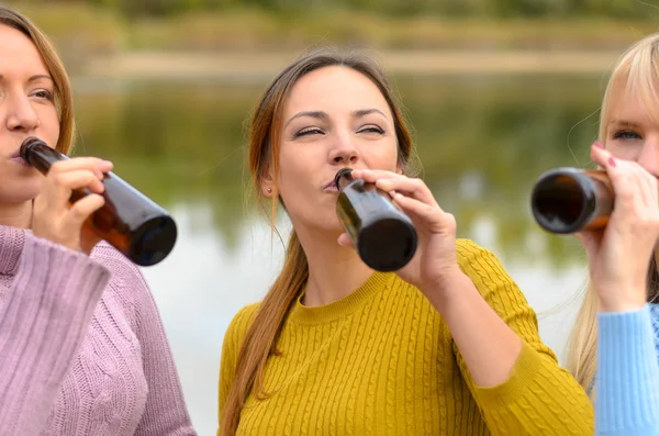 Three women friends enjoying a beer together