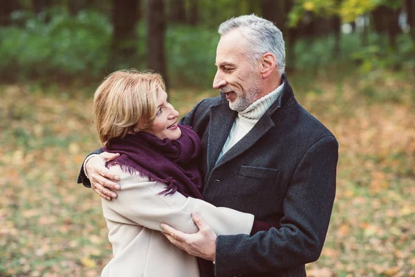 Mature couple embracing in park
