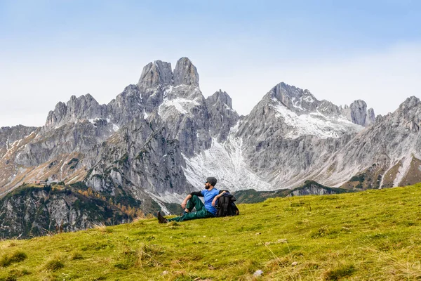 Traveler man enjoying serene view mountains landscape Eco tourism concept. Lifestyle of hiking. Summer or autumn vacations outdoor. Alps mountains Austria Europe