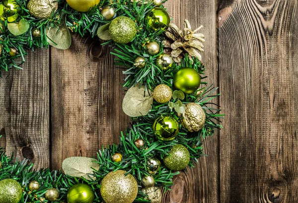 Christmas wreath on rustic wooden door. Advent decoration with ornaments