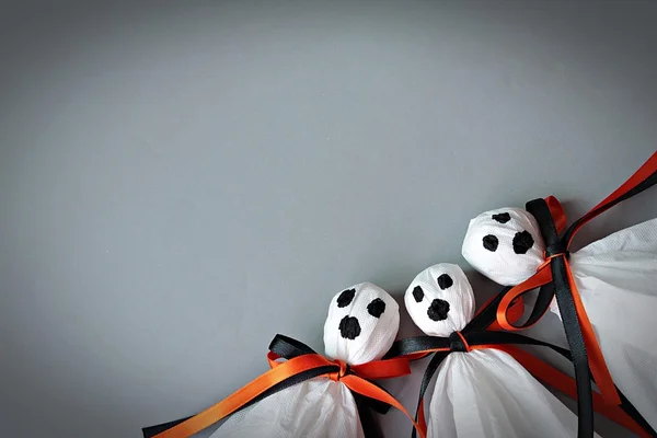 Halloween concept background : Three halloween ghosts DIY made from white tissue paper, black and orange ribbon