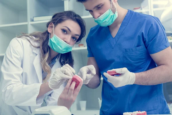 Dental students while working on the denture
