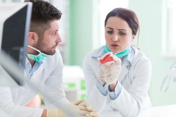 Dental students while working on the denture