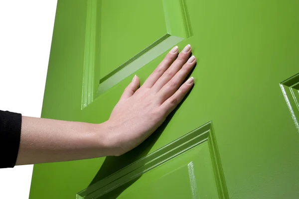 Woman pushes a green door open