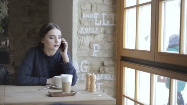 Woman with smartphone in cafe — Stock Video