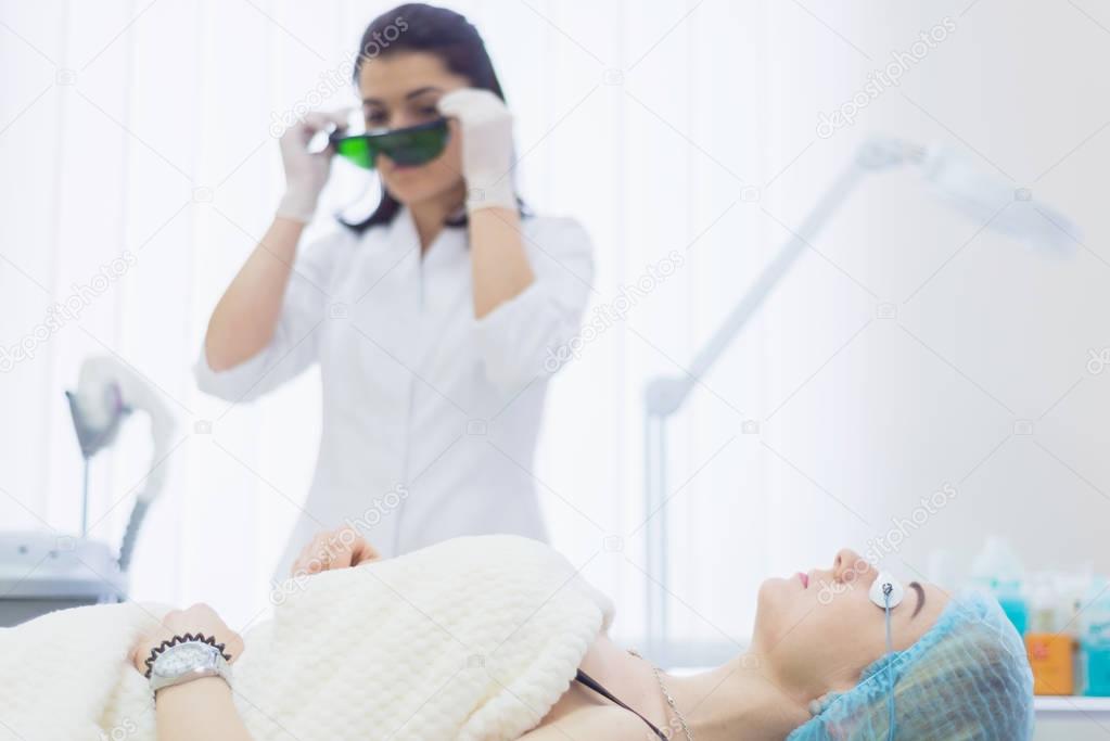 Doctor beautician wears Protective goggles