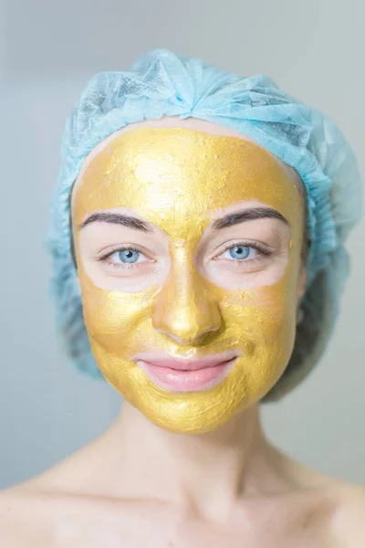 woman with gold facial mask