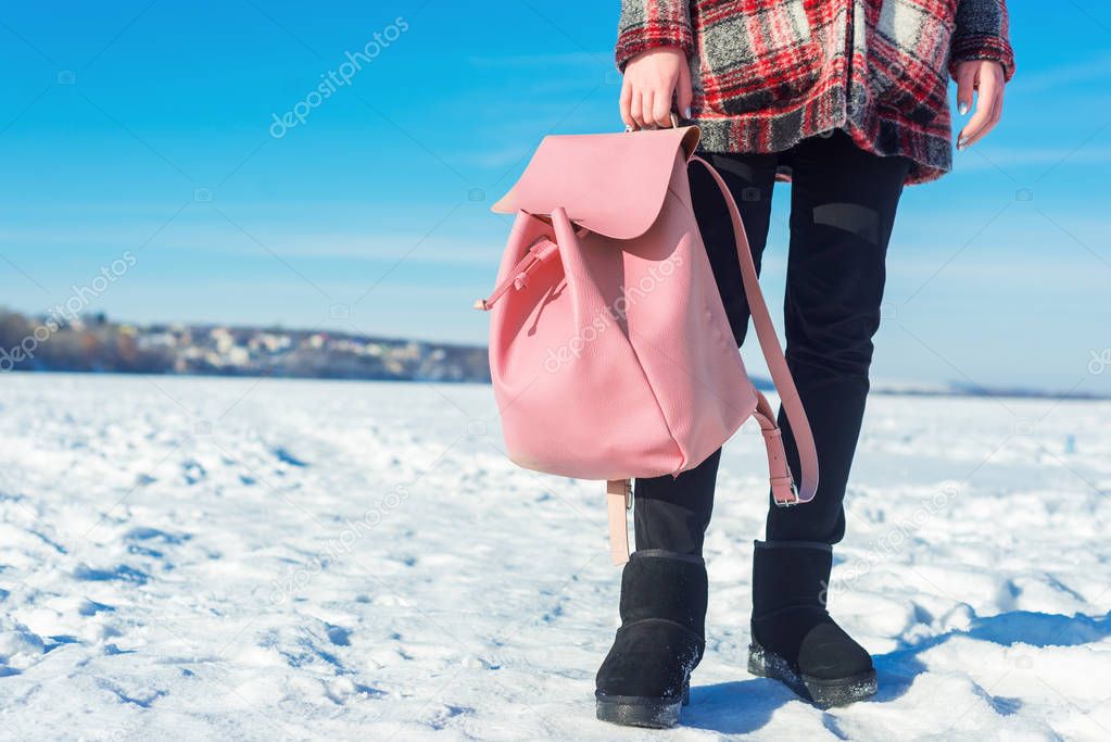 Girl holding pink backpack