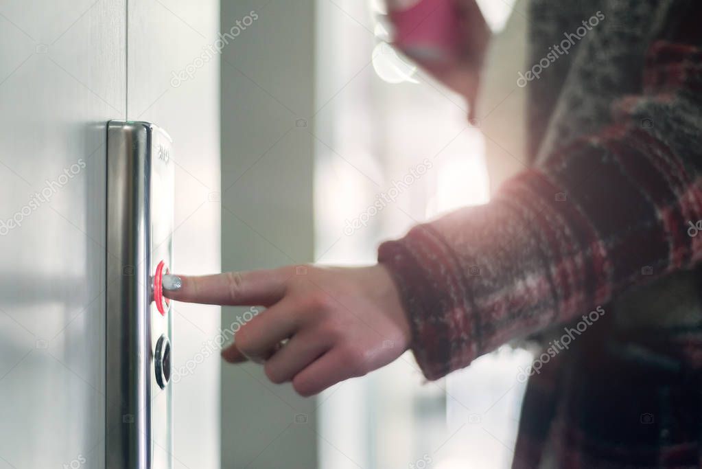 Woman Pushing button of elevator
