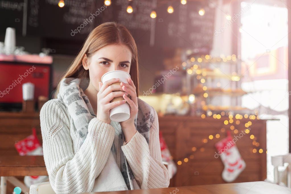 woman drinking coffee at a cafe