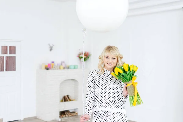 Happy woman with yellow tulips