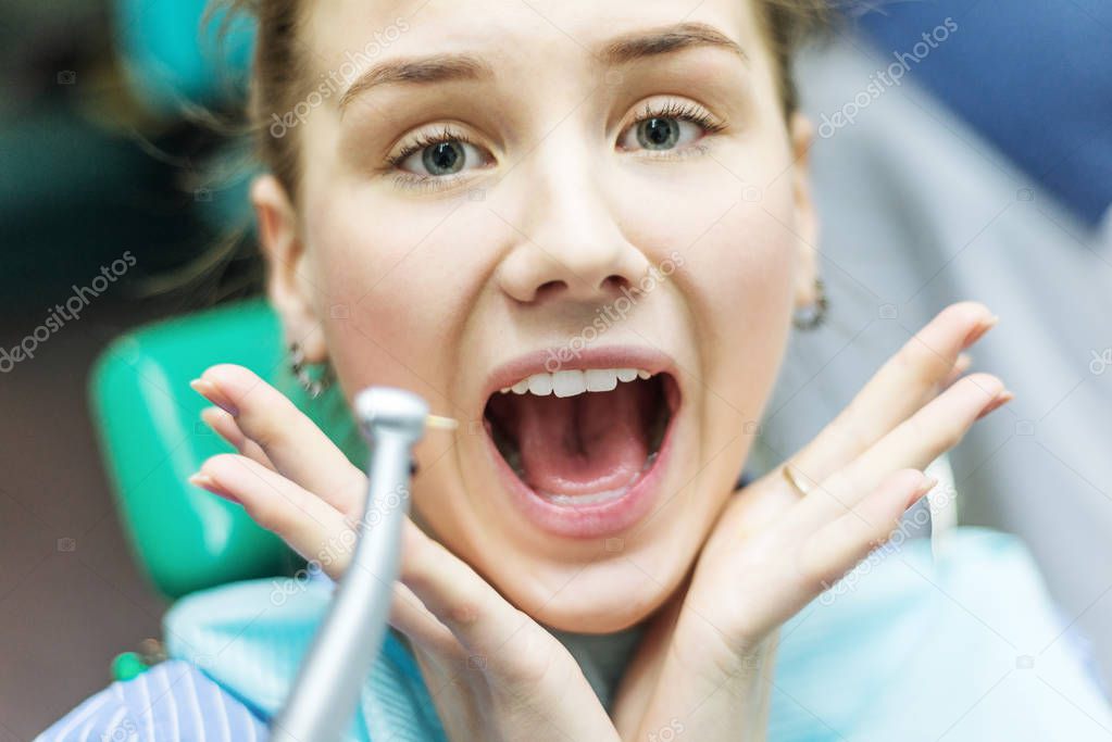Closeup portrait young terrified girl woman scared at dentist vi