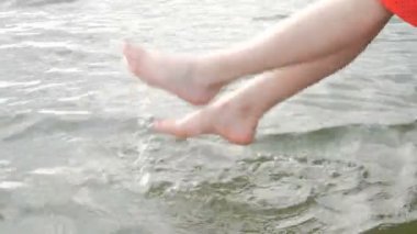 Suda ayak. Ayak. Oynama ve göldeki su ile eğlenirken kadın bacakları.