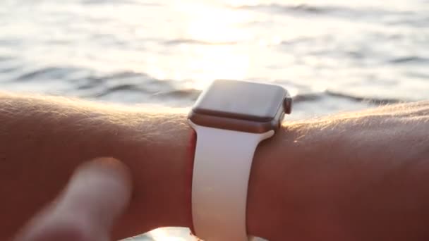 Man making various gestures with a finger on a touch screen of a smart watch wearable device. — Stock Video