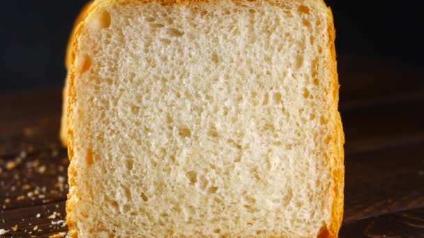 Sliced loaf of bread on black background — Stock Video