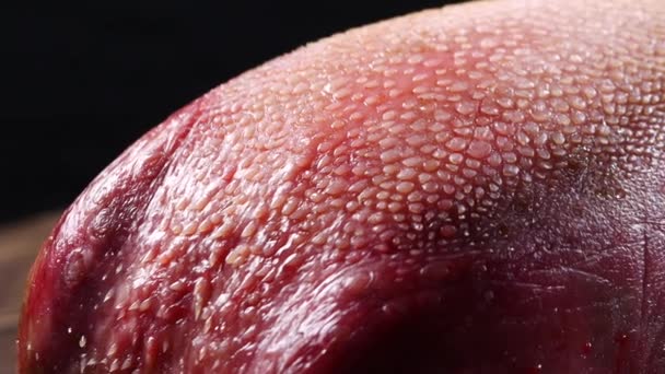 Surowej wołowiny różowy Zastraszyć język na czarnym tle — Wideo stockowe