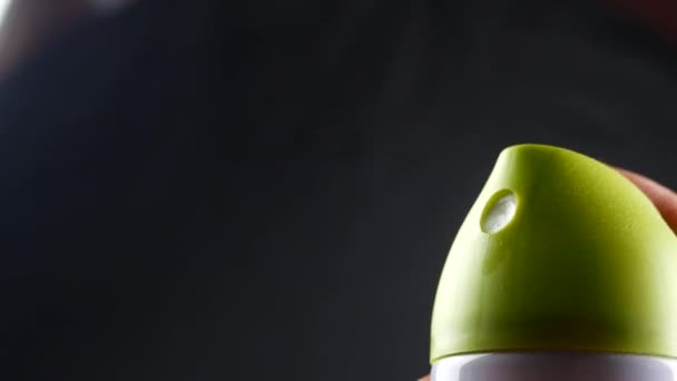 Nastříkané vzduchu osvěžovač v ruce detail na černém pozadí, deodorant baloon s plynem — Stock video