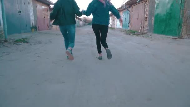 Duas raparigas a correr pela garagem. agitar o efeito da câmera — Vídeo de Stock