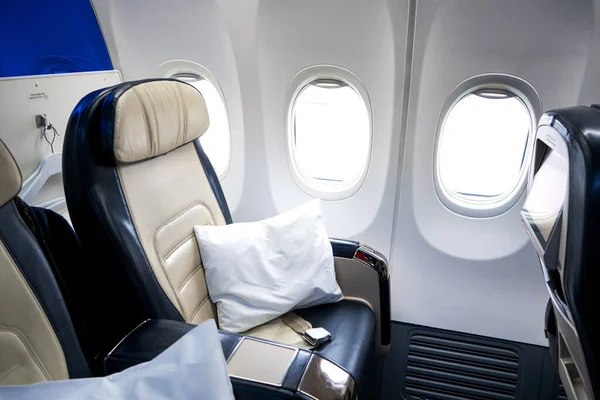 The interior of the aircraft. Empty airplane cabin. Seats for passengers in the business class compartment.